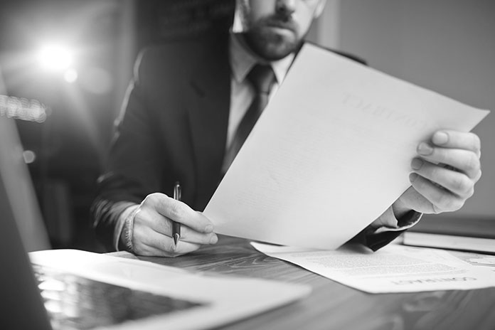 lawyer looking over document provided by transcription services